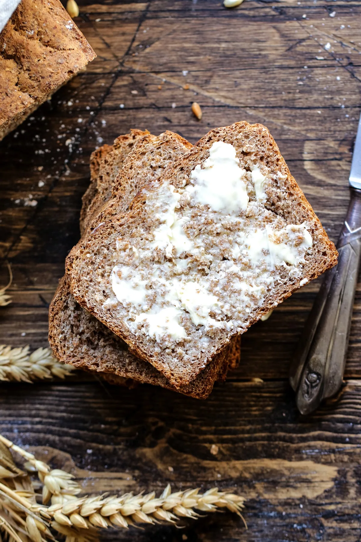 A slice of homemade spelt bread smeared with vegan butter