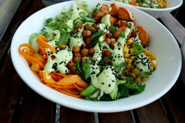 Healthy Veggie Bowls Recipe: Roasted Sweet Potatoes and Chick Peas with Stir Fried Napa Cabbage, Corn, Carrots and Scallions with Avocado Dressing.