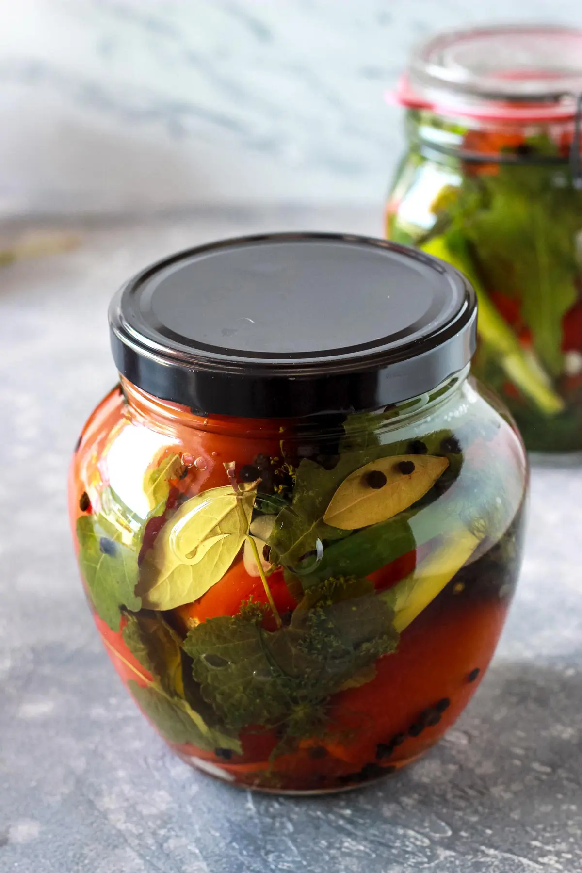 A sealed jar with pickled tomatoes.