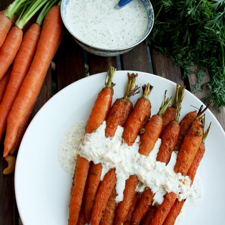 A new healthy way to enjoy carrots: Indian spiced roasted carrots with 5-minutes cashew feta dip. Flavorful, unusual and easy-to-make. Vegan recipe provided
