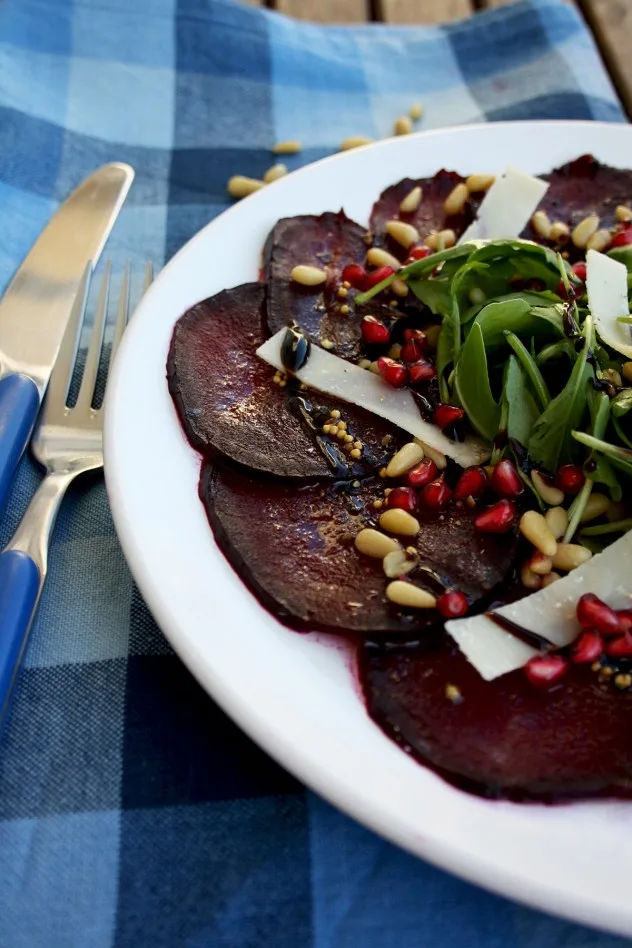 A beautiful, effortless, healthy and flavorful beetroot carpaccio with orange mustard vinaigrette and pomegranate seeds, served with parmesan and arugula.