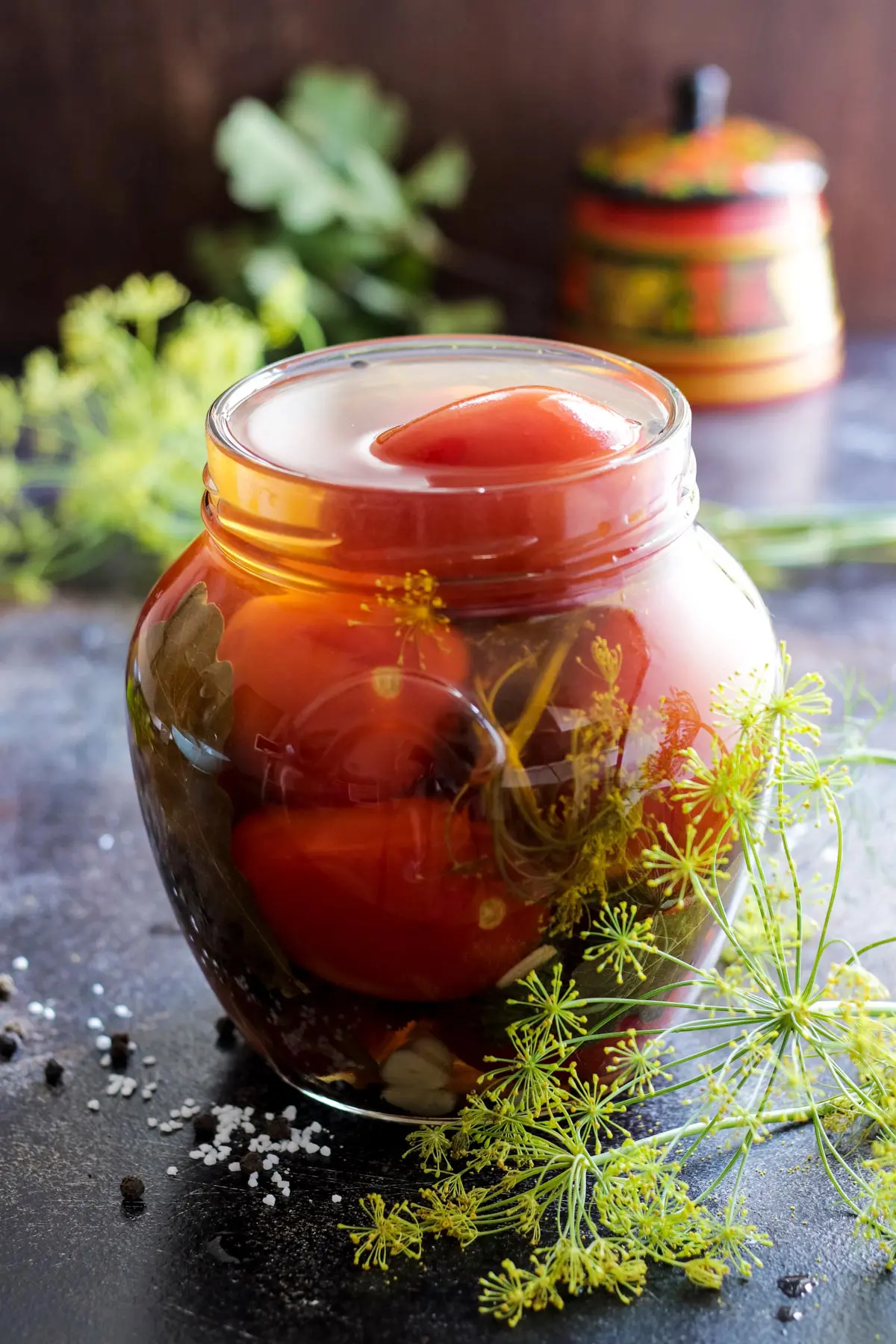 Opened jar with pickled tomatoes.