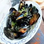 Mussels in White Wine Sauce: Easy 10-minute recipe of a fancy and delicious dinner. Steam mussels with onion, garlic, white wine. Serve with fresh ciabatta.