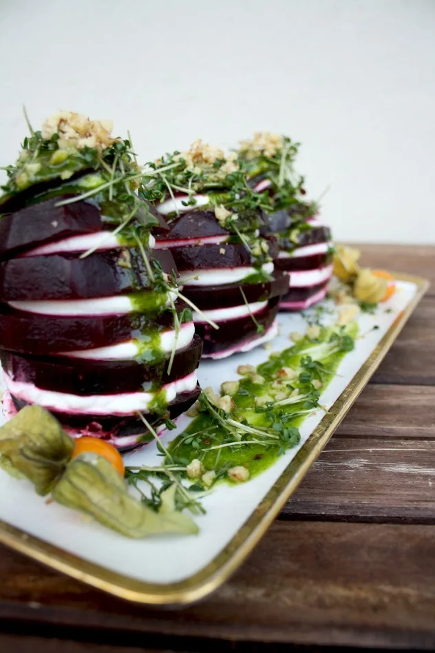 Beetroot Towers with Goat Cheese and Green Sauce Dressing: Impressive and fancy entrée ready in 10 minutes! Garnished with ground cherries, garden cress and walnuts.