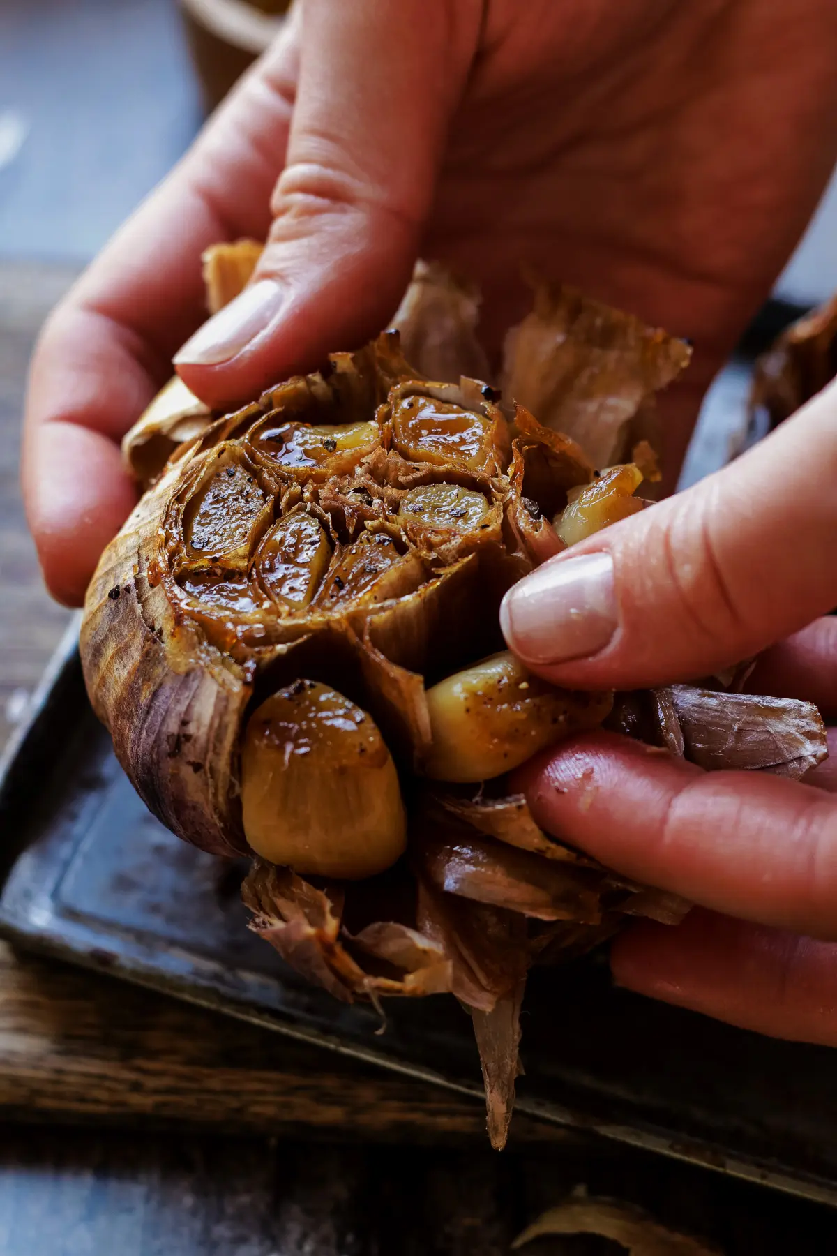 Peeling roasted garlic by hand.