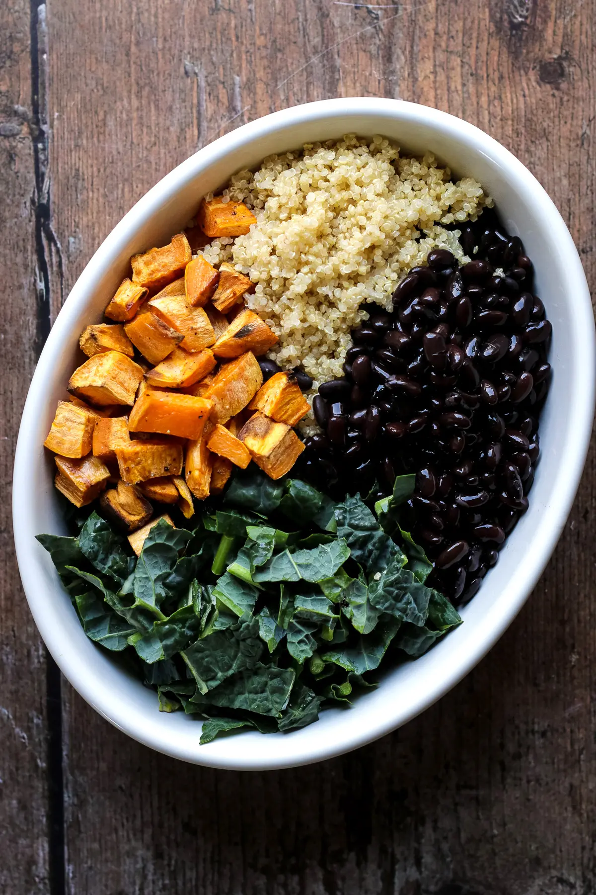 Sweet potato casserole with kale black beans and quinoa before adding the sauce.