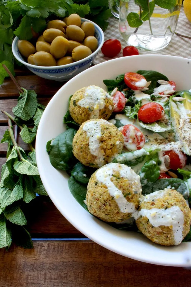 Crispy Baked Falafel with Hazelnuts and Creamy Lemon-Mint Sauce - Delicious Meal Served with Greens