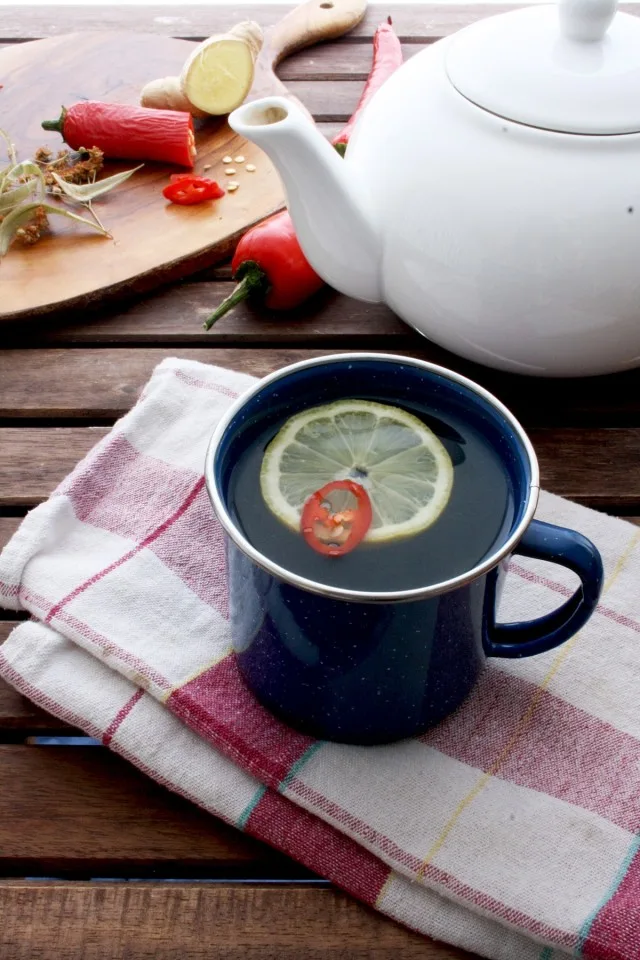 Natural Flu Remedy: Magic 4-Ingredient Tea in a Cup with a Lemon Piece Inside