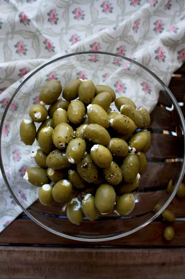Cream Cheese Stuffed Olives Overhead on a Glass Bowl Full of Olives