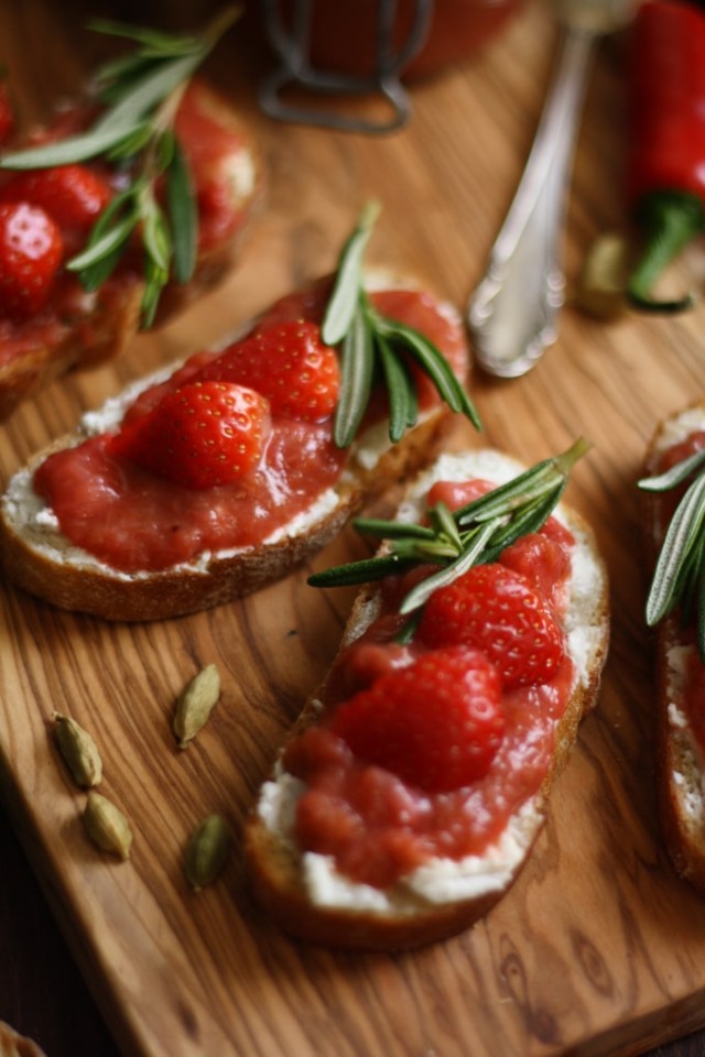 Goat Cheese Crostini with Rhubarb Chutney Served on a Wooden Table, Decorated with Rosemary