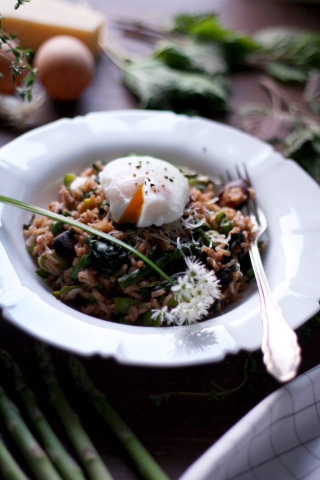 Spring Brown Rice Risotto with an Egg on Top in a White Plate