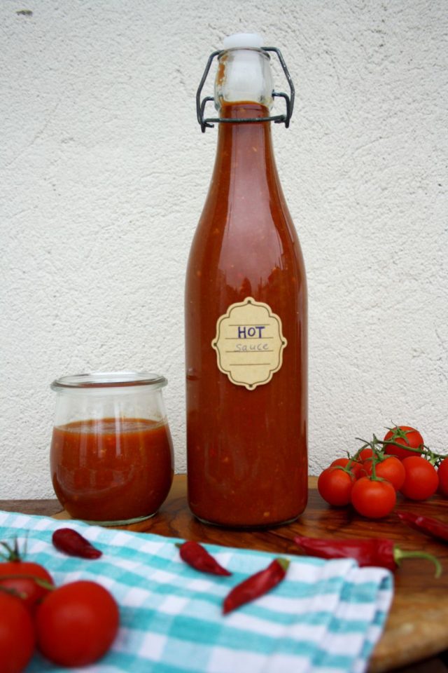 Quick Homemade Sriracha in a Bottle on a Small Table