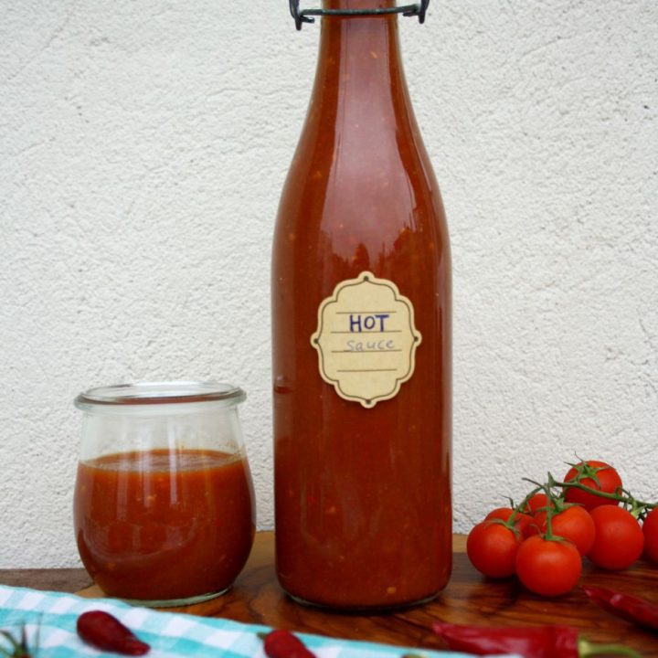 Quick Homemade Sriracha in a Bottle on a Small Table