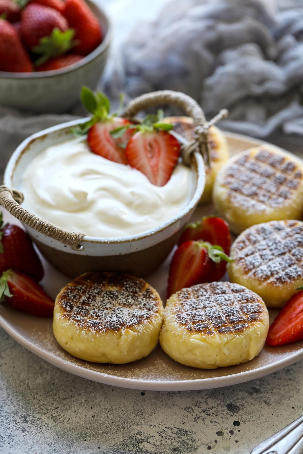 Russian Syrniki with yogurt and strawberries.