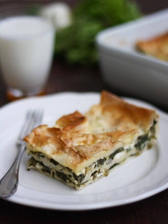 Turkish Boerek with Spinach and Feta Cheese Served on a White Plate with a Fork Next to It