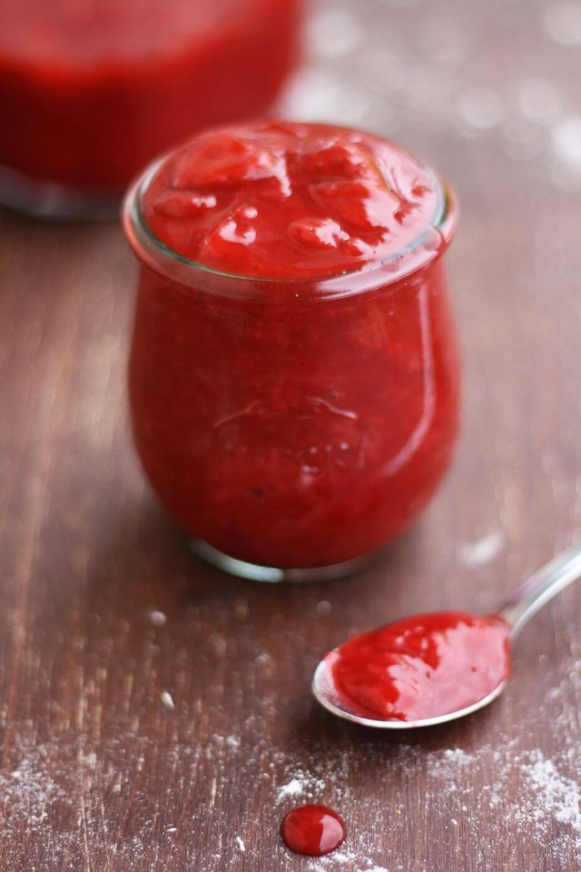 Strawberry Sauce in a Jar Next to a Spoon