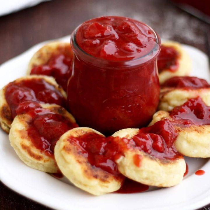 Russian Syrniki with Strawberry Sauce - Served in a White Plate with the Sauce in the Center