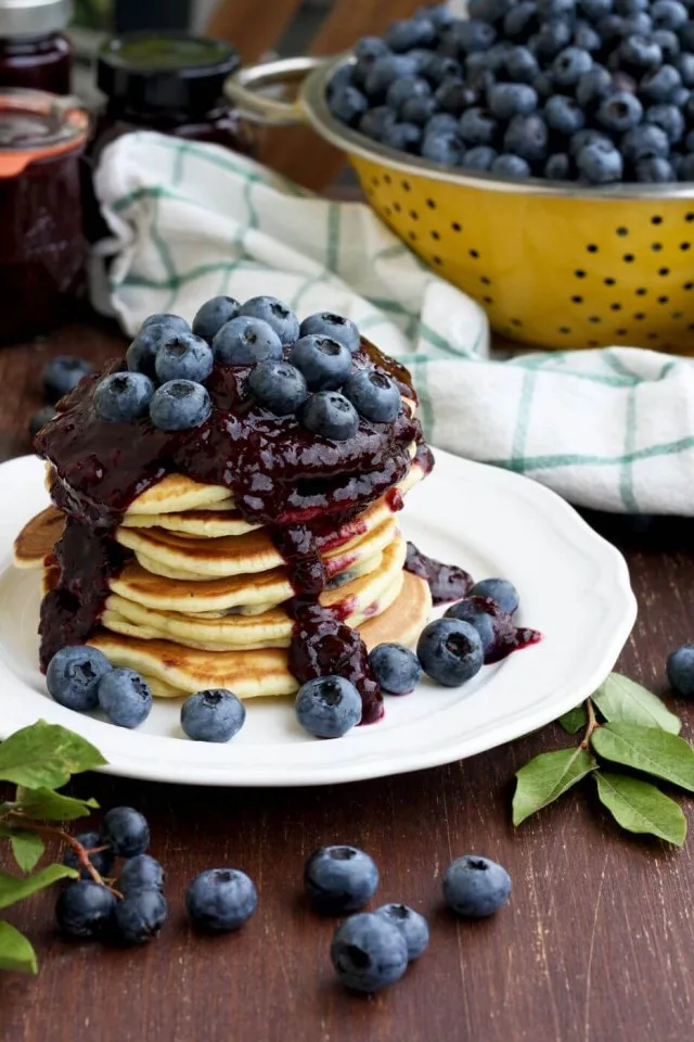 Blueberry Ricotta Pancakes with a Fork on the Side and a Missing Piece