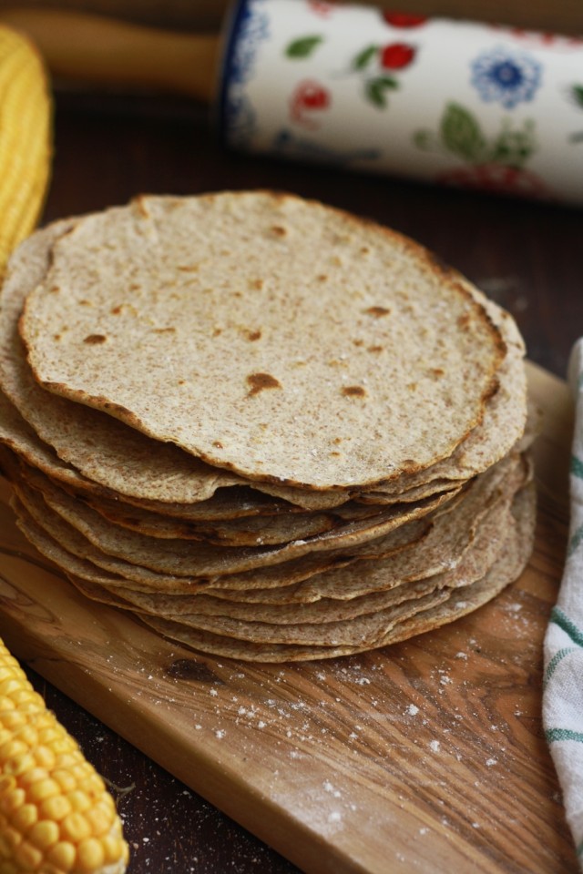 Homemade Whole Wheat Tortilla on a Wooden Board with Some Corn on the Sides
