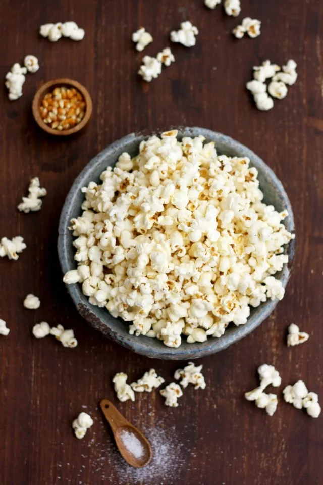 Always Perfect Stovetop Popcorn Overhead Shot with Raw Corn in a Tiny Little Bowl