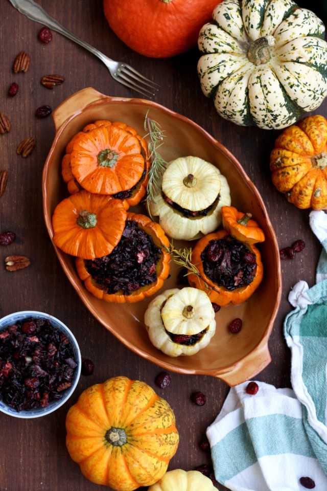 Easy Halloween carved pumpkins with wholesome wild rice stuffing. Serve these spooky kid-friendly stuffed pumpkins for a healthy holiday treat!