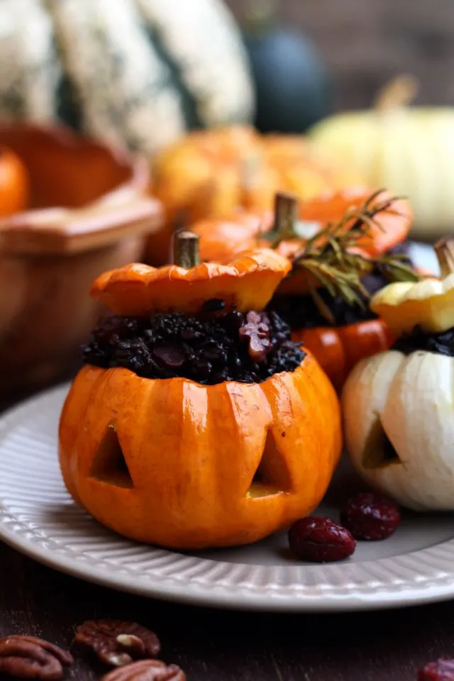Easy Halloween carved pumpkins with wholesome wild rice stuffing. Serve these spooky kid-friendly stuffed pumpkins for a healthy holiday treat!