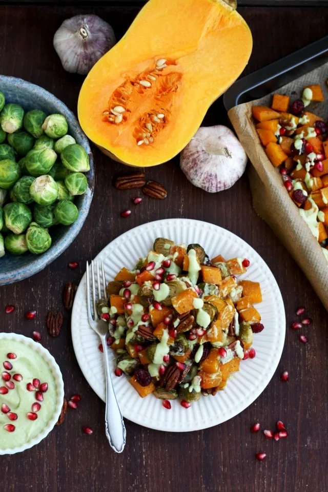 Roasted Brussels Sprouts with Butternut Squash on the Table with Raw Ingredients Around It