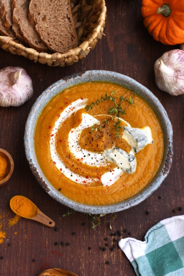 A Bowl of Butternut Squash Soup with Spices and Bread