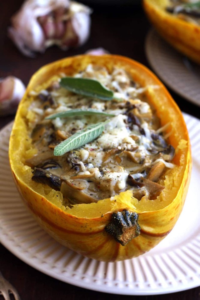 Roasted Spaghetti Squash with Mushrooms on the Table with Garlic Cloves in the Background