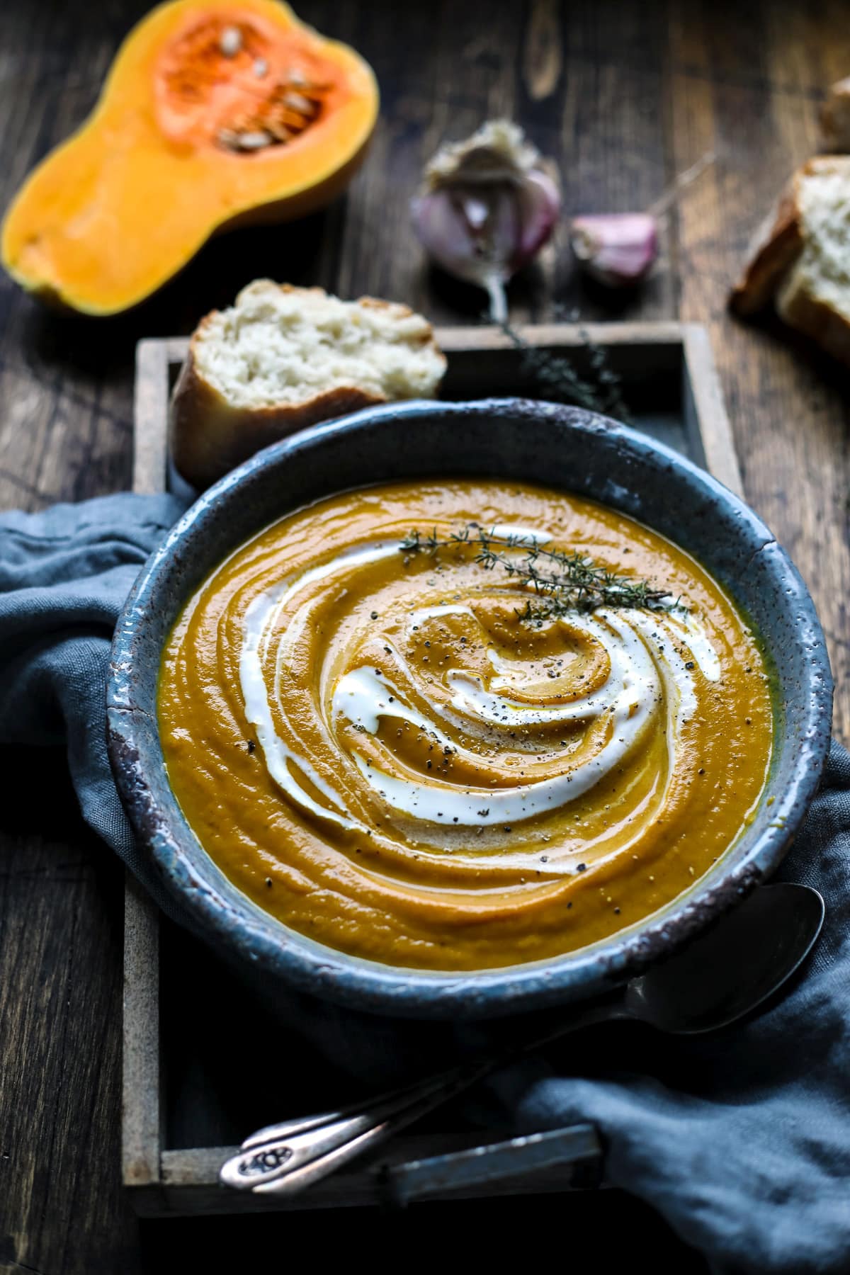 Vegan Butternut Squash Soup in a Plate Surrounded With Ingredients.