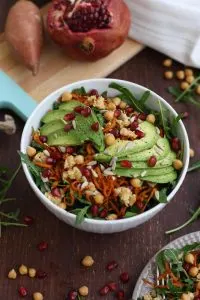 Healthy Sweet Potato Noodle Salad with Chickpeas and Rocket with Pomegranate Seeds Around the Bowl