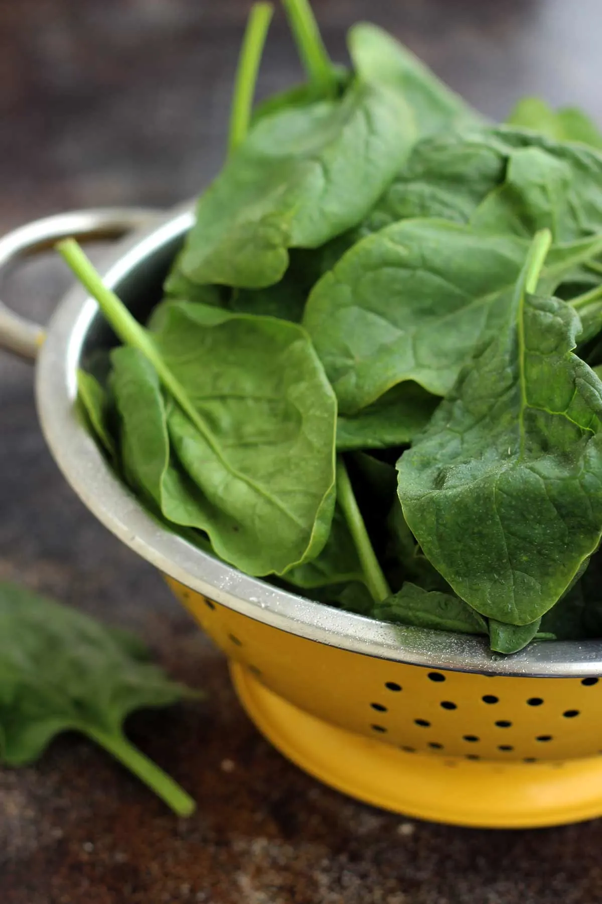 Fresh Spinach in a Yellow Sieve