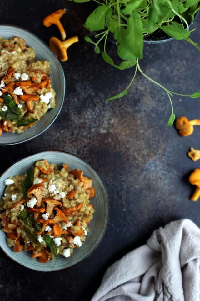Easy Barley Risotto with Mushroom and Goat Cheese in Bowls Flatlay - Negative Space