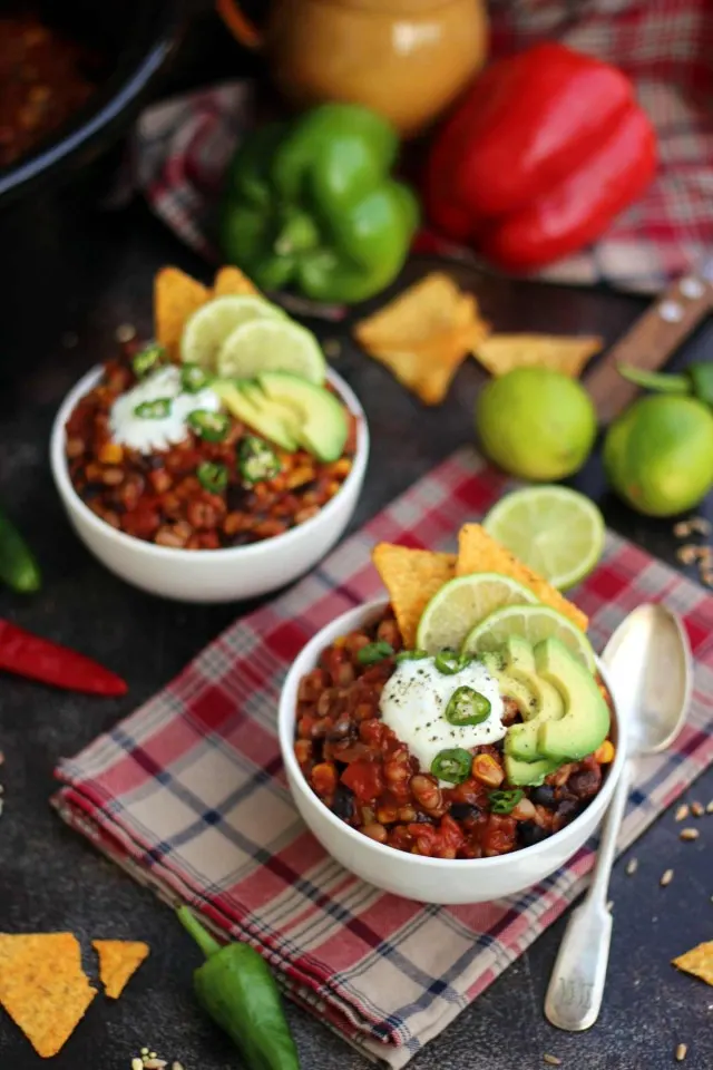 Bowls of Vegan Chili with Garnishes on a Napkin