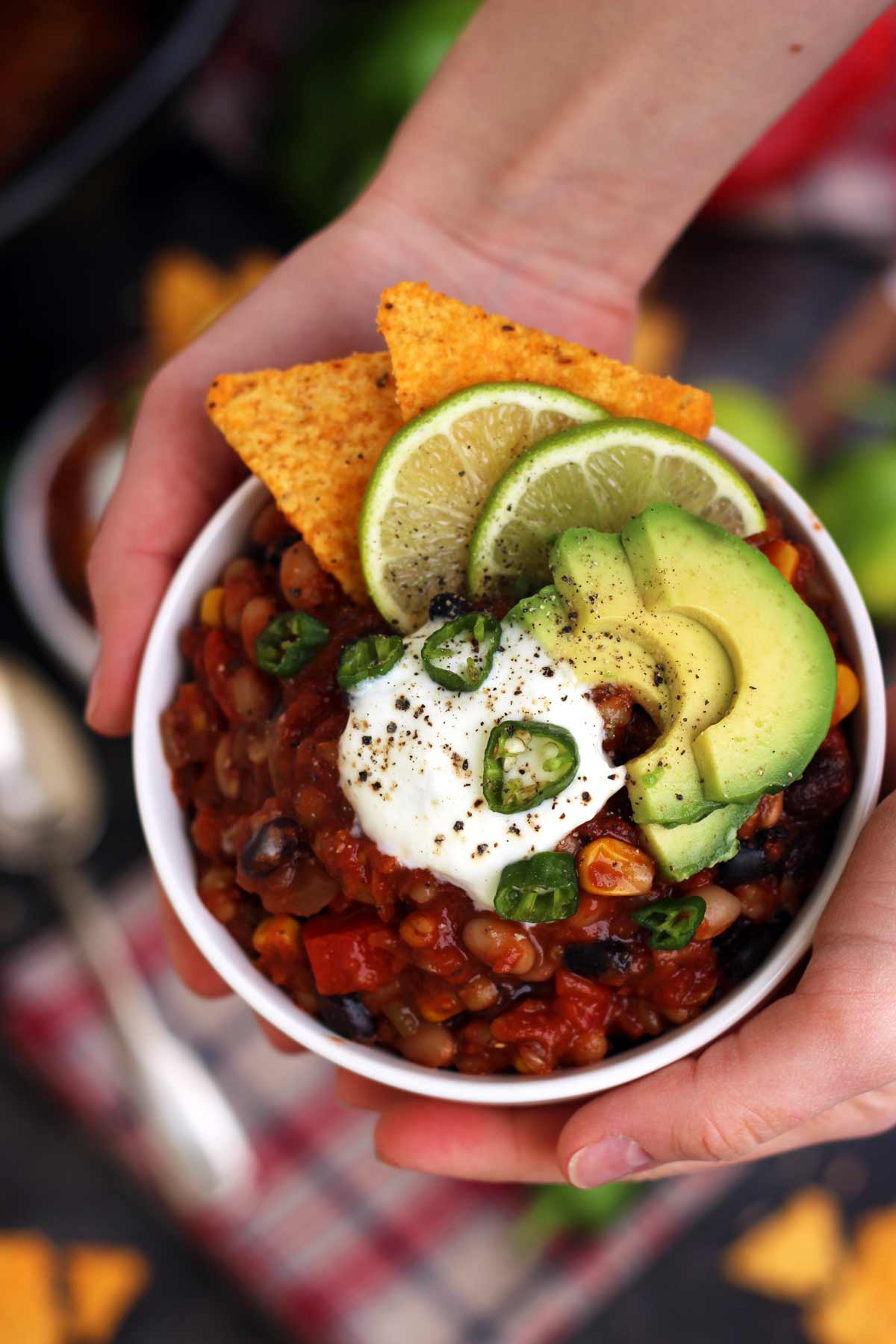 Hands Holding a Bowl of Vegan Chili