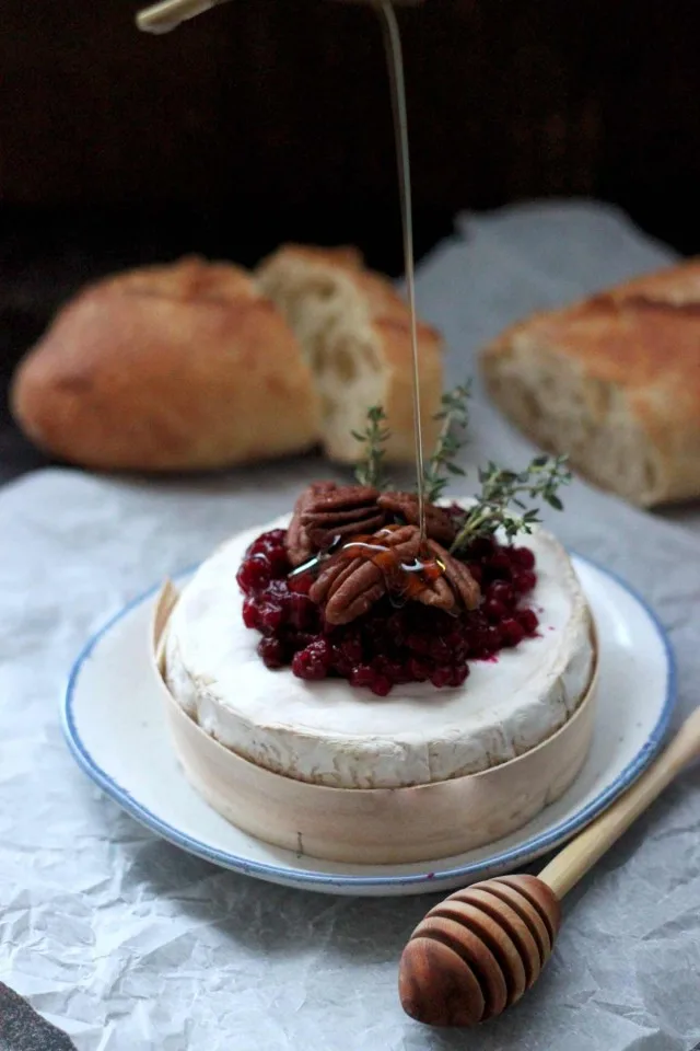 Easy Cranberry Baked Brie with Thyme Drizzled with Honey over Pecans