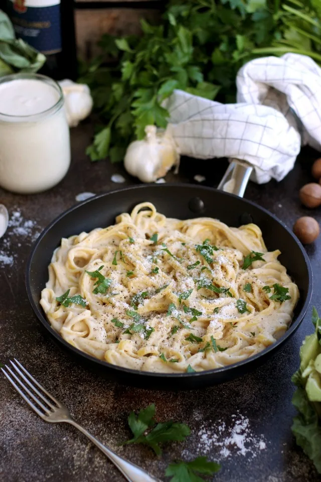 The Creamiest Vegan Fettuccine Alfredo - in a Skillet Garnished and Ready for Dinner