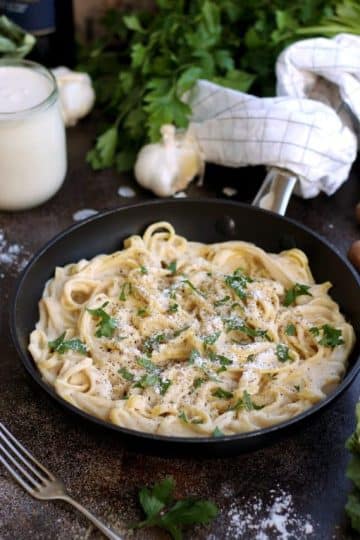 The Creamiest Vegan Fettuccine Alfredo - in a Skillet Garnished and Ready for Dinner