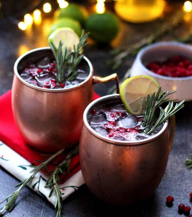 Cranberry Moscow Mule - Served in Copper Mugs with Lights in the Background