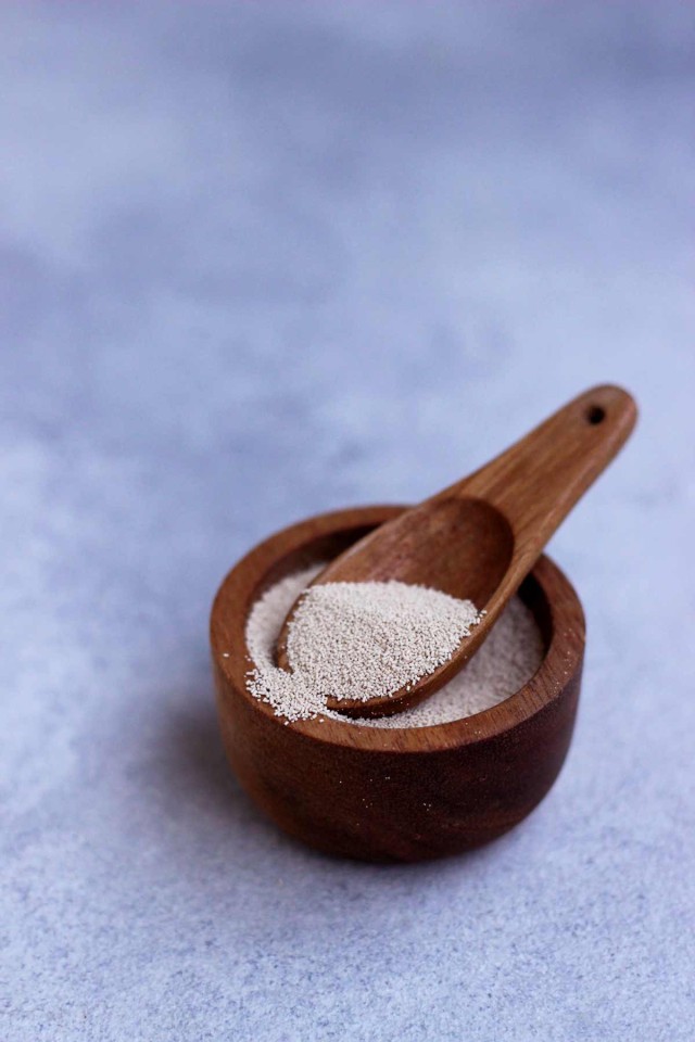 Brewer's Yeast in a Wooden Bowl with a Small Spoon