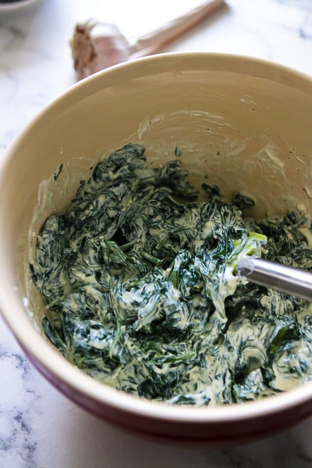 Ricotta and Spinach Filling in a Large Mixing Bowl with a Rubber Spatula