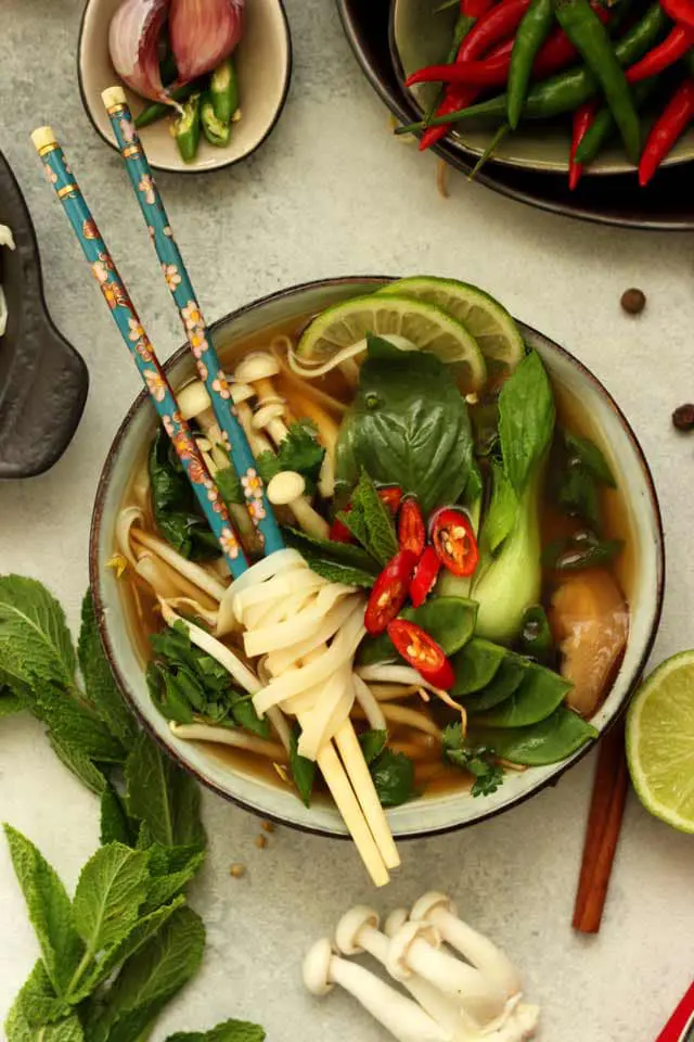 A Bowl of Vegan Pho with Chopsticks and Rice Noodles