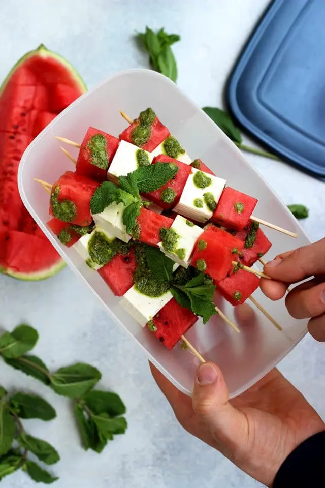 These take-along watermelon skewers with feta and mint pesto dressing are a quick and easy appetizer or snack for your next outdoor gathering, BBQ or picnic! Enjoy these delicious and healthy watermelon skewers on a hot summer day!