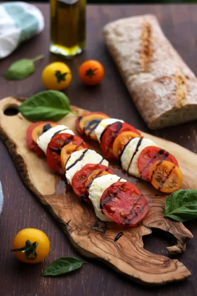 Classic Insalata Caprese (Tomato Mozzarella Salad) is the perfect quick appetizer or salad packed with summer flavors! Light, refreshing and so easy to make! A great way to enjoy in-season tomatoes at the fullest.