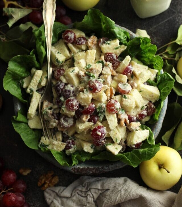 Healthy Vegan Waldorf Salad Recipe - with Apples and Grapes on the Table and a Fork in the Salad