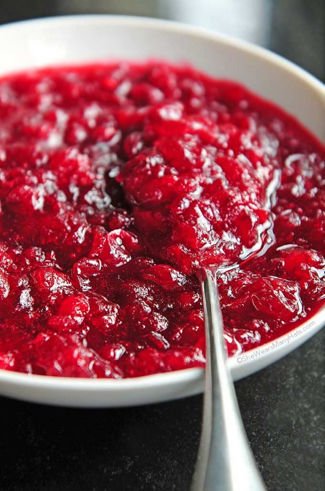 Homemade Cranberry Sauce in a bowl with a spoon.