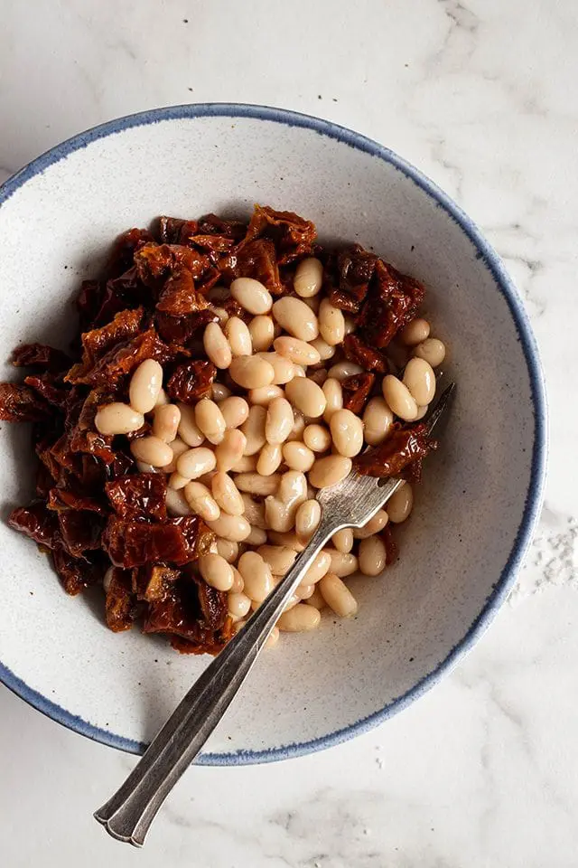 Sun-dried tomatoes and cannellini beans in a bowl