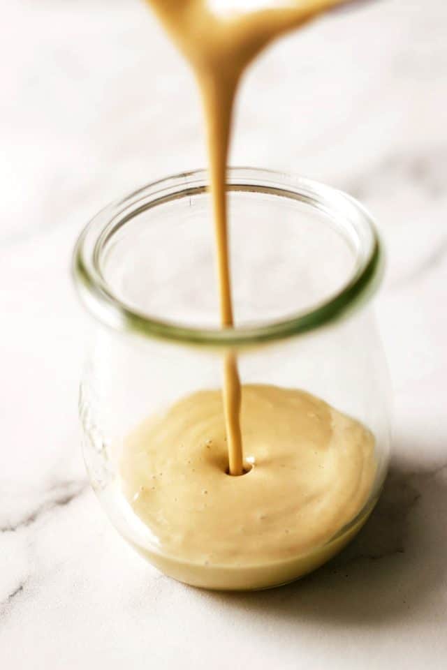 Tahini Dressing Being Poured in a Jar