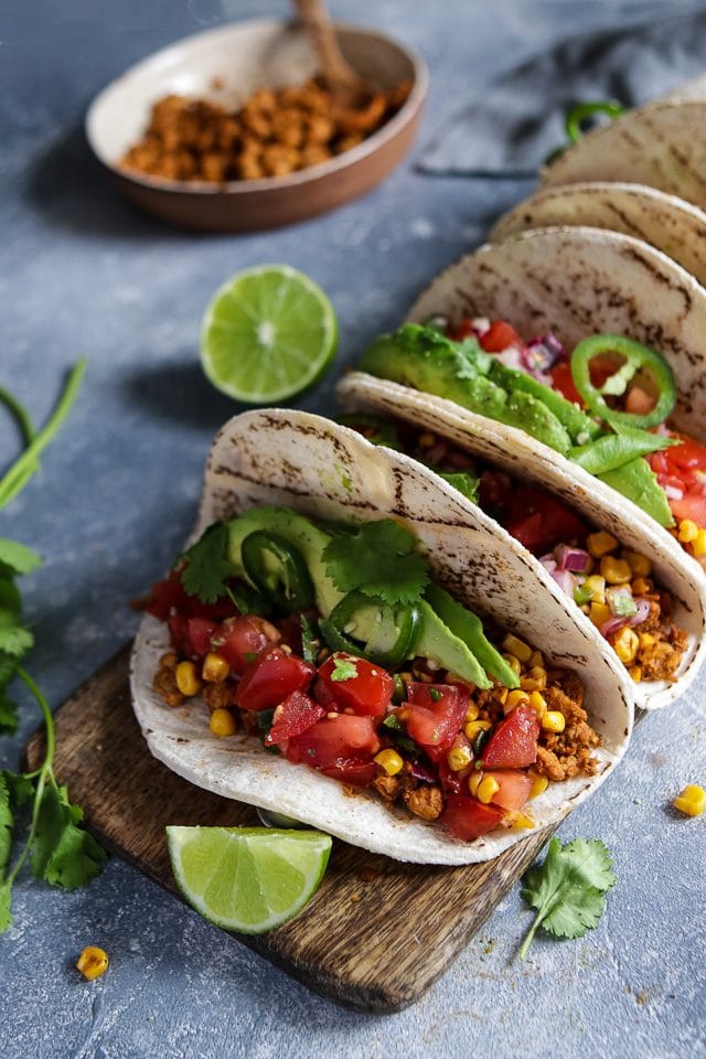 Vegan Tempeh Tacos with Corn and Tomatoes on a Wooden Board