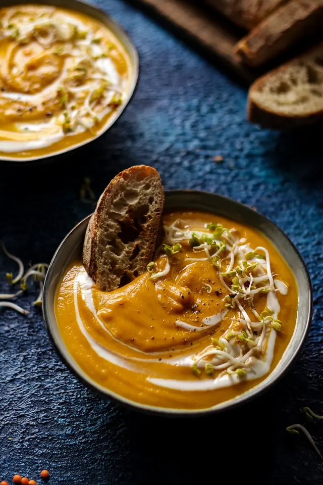 A Bowl of Sweet Potato Lentil Soup with a Slice of Crusty Bread